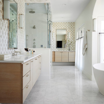 Inspiration for a mediterranean master beige tile double-sink and white floor bathroom remodel in Dallas with flat-panel cabinets, light wood cabinets, white walls, an undermount sink, a hinged shower door, white countertops and a floating vanity