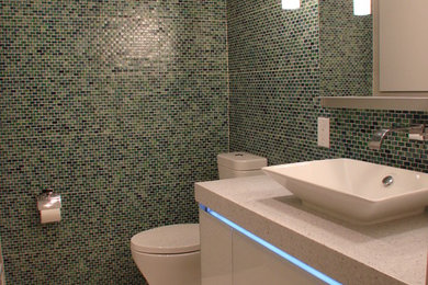Mid-sized minimalist blue tile, green tile and mosaic tile porcelain tile and beige floor bathroom photo in DC Metro with flat-panel cabinets, white cabinets, a one-piece toilet, multicolored walls and a vessel sink