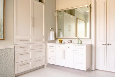 Example of a mid-sized minimalist master porcelain tile and beige floor bathroom design in Dallas with recessed-panel cabinets, beige cabinets, beige walls, an undermount sink, a hinged shower door and beige countertops