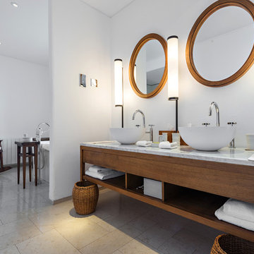 Modern bathroom interior with subtle lighting and circular mirrors