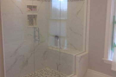 Alcove shower - transitional white tile and ceramic tile ceramic tile and white floor alcove shower idea in Toronto with gray walls and a hinged shower door