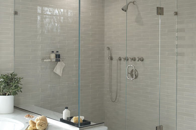 Inspiration for a mid-sized modern master beige tile and ceramic tile ceramic tile and multicolored floor corner shower remodel in New York with an undermount tub, beige walls, a hinged shower door, recessed-panel cabinets, white cabinets, a one-piece toilet, an undermount sink and granite countertops