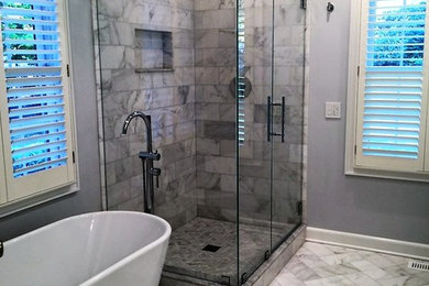 Example of a large trendy master gray tile and marble tile marble floor and gray floor bathroom design in New York with purple walls, a hinged shower door, white cabinets and shaker cabinets