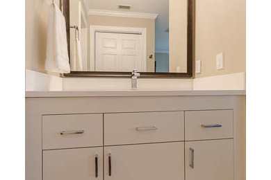 Inspiration for a mid-sized modern 3/4 light wood floor bathroom remodel in Jacksonville with flat-panel cabinets, white cabinets, beige walls and an undermount sink
