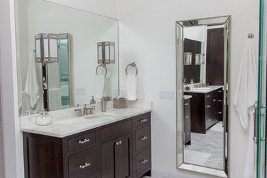 Inspiration for a large contemporary master gray tile and porcelain tile porcelain tile bathroom remodel in Phoenix with flat-panel cabinets, a two-piece toilet, white walls, an undermount sink, marble countertops and dark wood cabinets