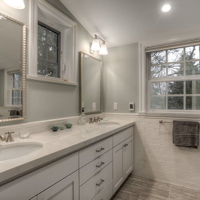 Inspiration for a large timeless master white tile and subway tile marble floor alcove shower remodel in Seattle with recessed-panel cabinets, white cabinets, a one-piece toilet, gray walls, an undermount sink and granite countertops