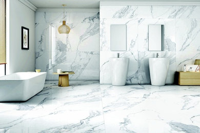 Inspiration for a large contemporary master white tile and marble tile marble floor and white floor bathroom remodel in Los Angeles with flat-panel cabinets, light wood cabinets, a bidet, white walls, a pedestal sink, marble countertops and a hinged shower door