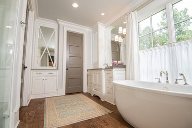 Bathroom - large modern master medium tone wood floor and brown floor bathroom idea in Other with recessed-panel cabinets, white cabinets, a two-piece toilet, white walls, an undermount sink, quartz countertops, a hinged shower door and gray countertops