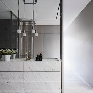 This is an example of a modern bathroom in Sydney with flat-panel cabinets, white cabinets, grey walls, an integrated sink, grey floor, white benchtops, a single vanity and a freestanding vanity.