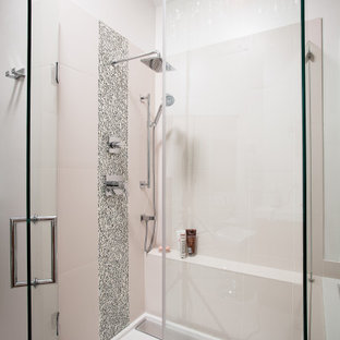 Mid-sized minimalist master beige tile and porcelain tile porcelain tile bathroom photo in Atlanta with an integrated sink, flat-panel cabinets, medium tone wood cabinets, solid surface countertops, a two-piece toilet and white walls