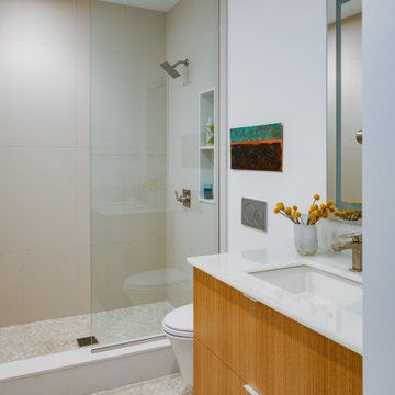 Modern Bathroom with Pebble Tiles and Wall-Mounted Vanity