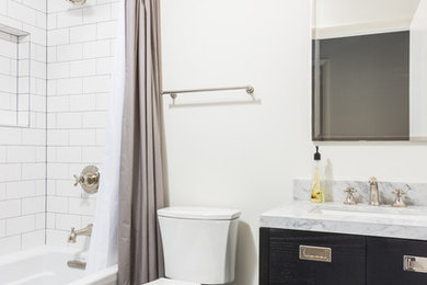 Inspiration for a mid-sized modern master white tile and subway tile vinyl floor bathroom remodel in Detroit with flat-panel cabinets, black cabinets, a one-piece toilet, white walls, an undermount sink and granite countertops