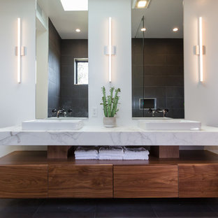 Example of a mid-sized minimalist master gray tile and ceramic tile porcelain tile and gray floor bathroom design in Los Angeles with flat-panel cabinets, dark wood cabinets, a two-piece toilet, gray walls, a vessel sink, marble countertops and white countertops