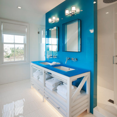 Beach style white floor bathroom photo in Boston with furniture-like cabinets, white cabinets, white walls, an undermount sink and blue countertops