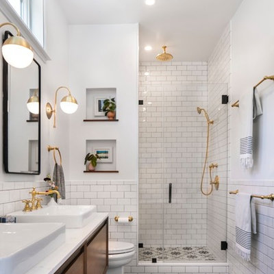 Example of a mid-sized transitional master white tile and ceramic tile mosaic tile floor and black floor alcove shower design in Los Angeles with flat-panel cabinets, white walls, a vessel sink, quartz countertops, a hinged shower door, white countertops and medium tone wood cabinets