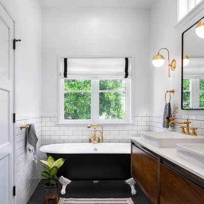 Mid-sized transitional master white tile and ceramic tile mosaic tile floor and black floor claw-foot bathtub photo in Los Angeles with flat-panel cabinets, white walls, a vessel sink, quartz countertops, white countertops and medium tone wood cabinets