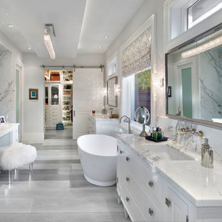 Design ideas for a traditional master bathroom in Miami with an undermount sink, white cabinets, a freestanding tub, white walls and raised-panel cabinets.