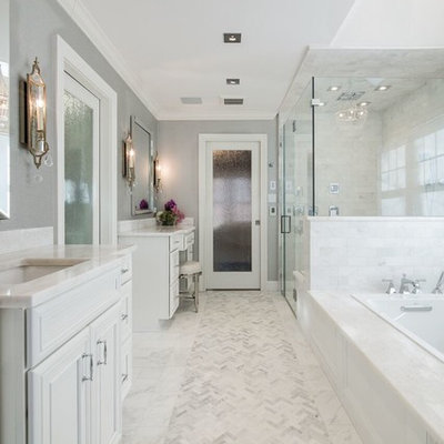 Inspiration for a timeless master white tile marble floor bathroom remodel in New York with gray walls, marble countertops, recessed-panel cabinets, white cabinets, an undermount sink and a hinged shower door