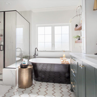 Example of a mid-sized farmhouse master white tile and porcelain tile porcelain tile, white floor, single-sink and wallpaper bathroom design in San Diego with recessed-panel cabinets, green cabinets, a two-piece toilet, white walls, an undermount sink, quartz countertops, a hinged shower door, white countertops and a built-in vanity