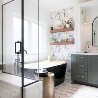 Inspiration for a mid-sized farmhouse master white tile and porcelain tile porcelain tile, white floor, single-sink and wallpaper bathroom remodel in San Diego with recessed-panel cabinets, green cabinets, a two-piece toilet, white walls, an undermount sink, quartz countertops, a hinged shower door, white countertops and a built-in vanity