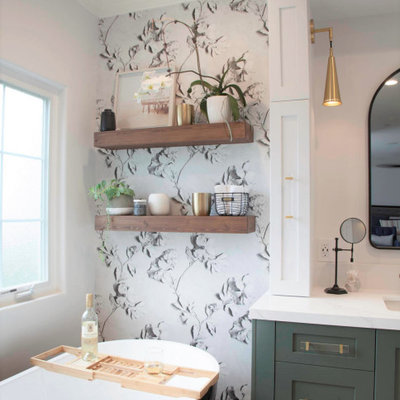 Mid-sized farmhouse master white tile and porcelain tile porcelain tile, white floor, single-sink and wallpaper bathroom photo in San Diego with recessed-panel cabinets, green cabinets, a two-piece toilet, white walls, an undermount sink, quartz countertops, a hinged shower door, white countertops and a built-in vanity