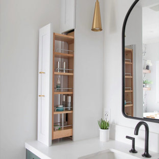 Inspiration for a mid-sized cottage master white tile and porcelain tile porcelain tile, white floor, single-sink and wallpaper bathroom remodel in San Diego with recessed-panel cabinets, green cabinets, a two-piece toilet, white walls, an undermount sink, quartz countertops, a hinged shower door, white countertops and a built-in vanity