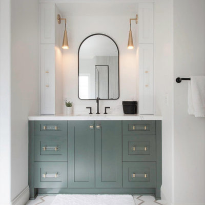 Inspiration for a mid-sized master white tile and porcelain tile porcelain tile, white floor, single-sink, wallpaper ceiling and wallpaper bathroom remodel in San Diego with recessed-panel cabinets, green cabinets, a two-piece toilet, white walls, an undermount sink, quartz countertops, a hinged shower door, white countertops and a built-in vanity