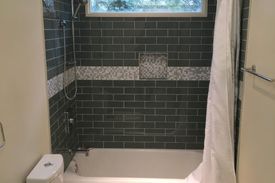 Inspiration for a mid-sized farmhouse blue tile and subway tile gray floor bathroom remodel in Other with furniture-like cabinets, gray cabinets, a one-piece toilet, beige walls, an integrated sink and quartz countertops