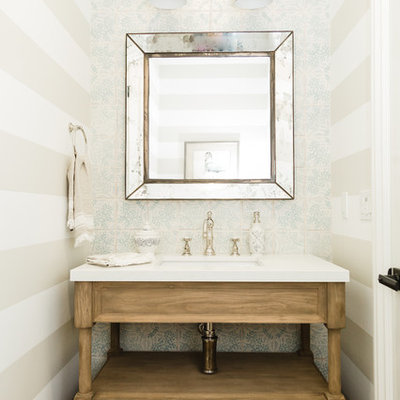 Beach style blue tile and white tile bathroom photo in San Diego with furniture-like cabinets, medium tone wood cabinets, multicolored walls, an undermount sink and white countertops