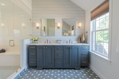 Alcove shower - large farmhouse master white tile and porcelain tile cement tile floor and blue floor alcove shower idea in Philadelphia with recessed-panel cabinets, blue cabinets, a one-piece toilet, white walls, an undermount sink, quartzite countertops, a hinged shower door and white countertops