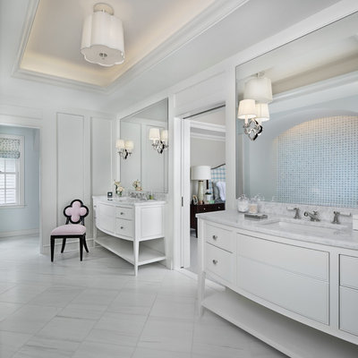 Huge beach style master travertine floor and white floor bathroom photo in Detroit with furniture-like cabinets, white cabinets, white walls, an undermount sink, marble countertops and white countertops