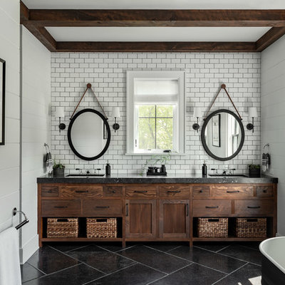 Large country master white tile and subway tile slate floor and black floor freestanding bathtub photo in New York with flat-panel cabinets, white walls, an undermount sink, concrete countertops, black countertops and dark wood cabinets