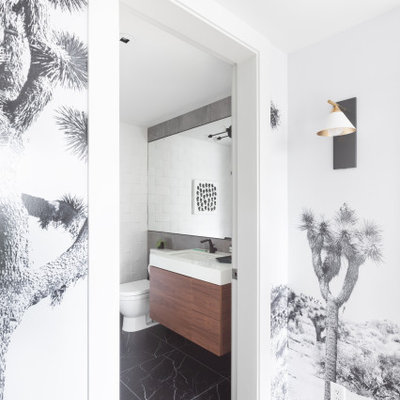 Example of a minimalist white tile black floor and single-sink bathroom design in Vancouver with dark wood cabinets, white walls, white countertops and a floating vanity