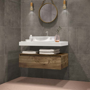 This is an example of a modern 3/4 bathroom in Miami with flat-panel cabinets, medium wood cabinets, gray tile, porcelain tile, grey walls, porcelain floors, white benchtops, a vessel sink and pink floor.