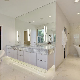 Inspiration for a mid-sized contemporary master white tile freestanding bathtub remodel in Austin with an undermount sink, flat-panel cabinets, white cabinets, quartzite countertops and white walls