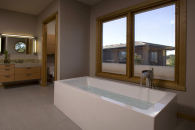 Large minimalist master multicolored tile freestanding bathtub photo in Sacramento with flat-panel cabinets, medium tone wood cabinets, an integrated sink and concrete countertops