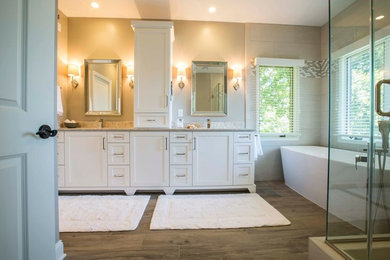 Large transitional master beige tile and porcelain tile medium tone wood floor bathroom photo in Other with recessed-panel cabinets, white cabinets, beige walls, an undermount sink and granite countertops