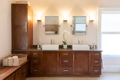 Inspiration for a contemporary bathroom remodel in Boston with a vessel sink and dark wood cabinets