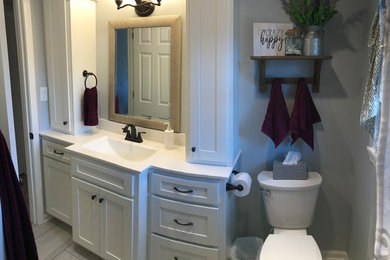 Inspiration for a mid-sized transitional bathroom remodel in Other with recessed-panel cabinets, white cabinets, a one-piece toilet, a drop-in sink and white countertops
