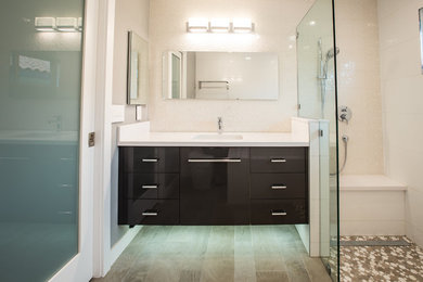 Example of a large trendy master bathroom design in Orange County with flat-panel cabinets and black cabinets