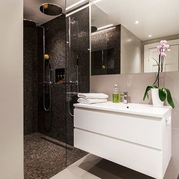 Modern white bathroom with black mosaic shower