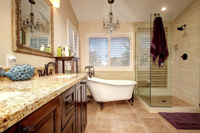 Inspiration for a mid-sized timeless master beige tile and porcelain tile travertine floor bathroom remodel in Phoenix with raised-panel cabinets, medium tone wood cabinets, beige walls, an undermount sink and granite countertops