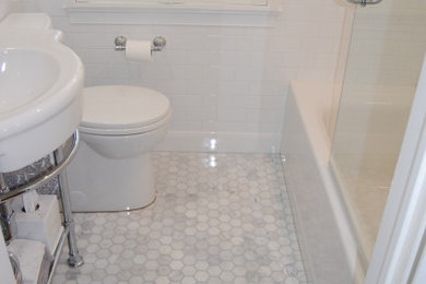 Photo of a medium sized traditional ensuite bathroom in Baltimore with open cabinets, an alcove bath, a shower/bath combination, a one-piece toilet, white tiles, ceramic tiles, blue walls, ceramic flooring, a console sink, multi-coloured floors and an open shower.