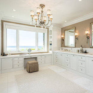 Example of a beach style white tile bathroom design in Orange County with an undermount sink, white cabinets and recessed-panel cabinets