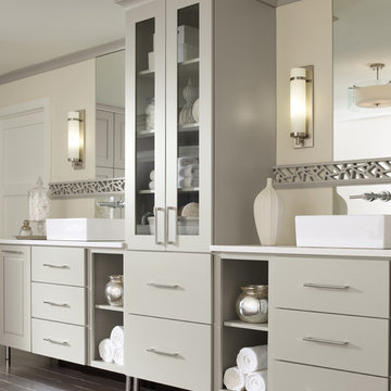 Monochromatic his-n-hers bathroom with high cabinets and flat-panel drawers