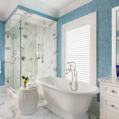 Bathroom - tropical master multicolored tile marble floor and multicolored floor bathroom idea in Miami with recessed-panel cabinets, white cabinets, multicolored walls, a hinged shower door and multicolored countertops
