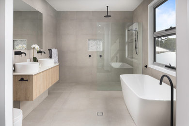 Scandi wet room bathroom in Brisbane with flat-panel cabinets, light wood cabinets, a freestanding bath, beige tiles, a vessel sink, beige floors, an open shower and white worktops.