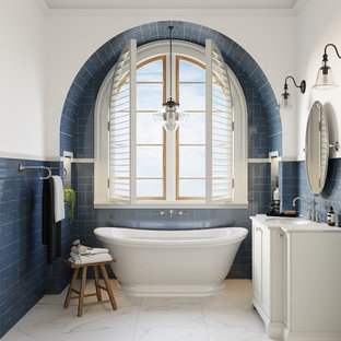 Traditional bathroom in Melbourne with white cabinets, a freestanding tub, blue tile, white walls, an undermount sink, white floor and white benchtops.