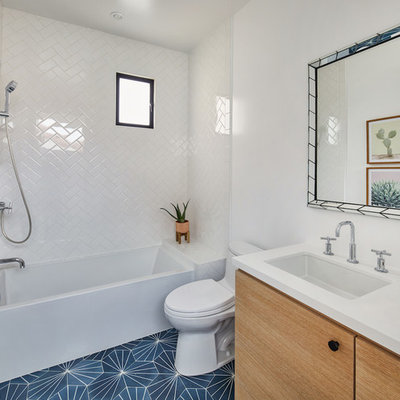 Inspiration for a small contemporary kids' white tile and ceramic tile cement tile floor and blue floor bathroom remodel in Los Angeles with flat-panel cabinets, light wood cabinets, a one-piece toilet, white walls, an undermount sink, quartz countertops and white countertops