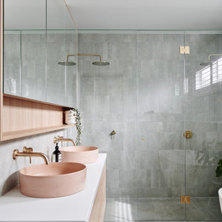 Design ideas for a large contemporary master bathroom in Melbourne with recessed-panel cabinets, light wood cabinets, a freestanding tub, a double shower, gray tile, ceramic tile, grey walls, ceramic floors, a vessel sink, engineered quartz benchtops, grey floor, a hinged shower door, white benchtops, a niche, a single vanity, a floating vanity and recessed.